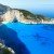 Top view on Navagio bay. Summer coastline view (Greece, Zakynthos, Ionian Sea). All people are not identifiable.